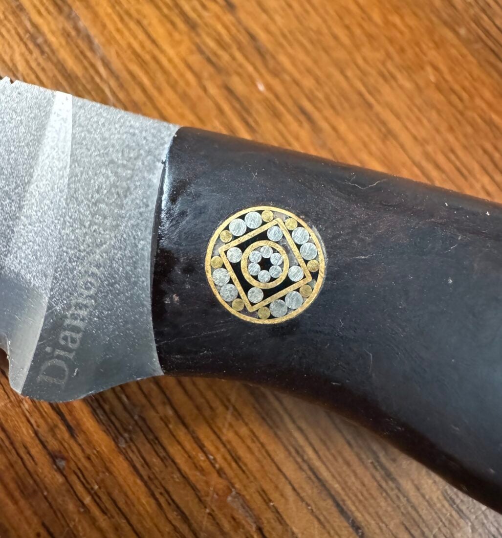 A detail of a pin bolster on a knife