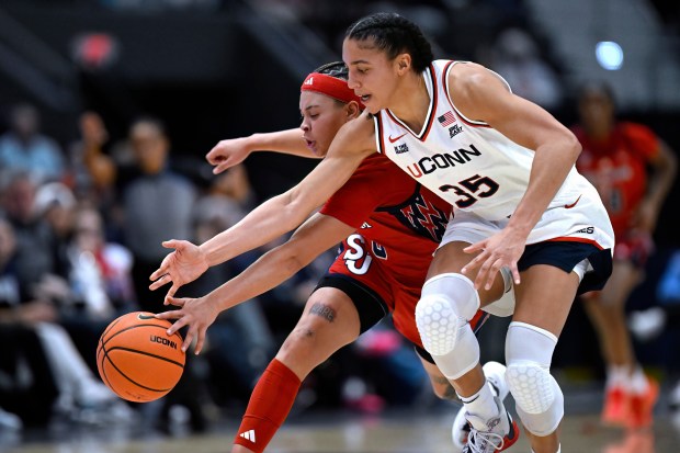 UConn guard Azzi Fudd (35) steals the ball from St. John's guard Shaulana Wagner (8) in the first half of an NCAA college basketball game, Wednesday, Jan. 7, 2026, in Hartford, Conn. (AP Photo/Jessica Hill)