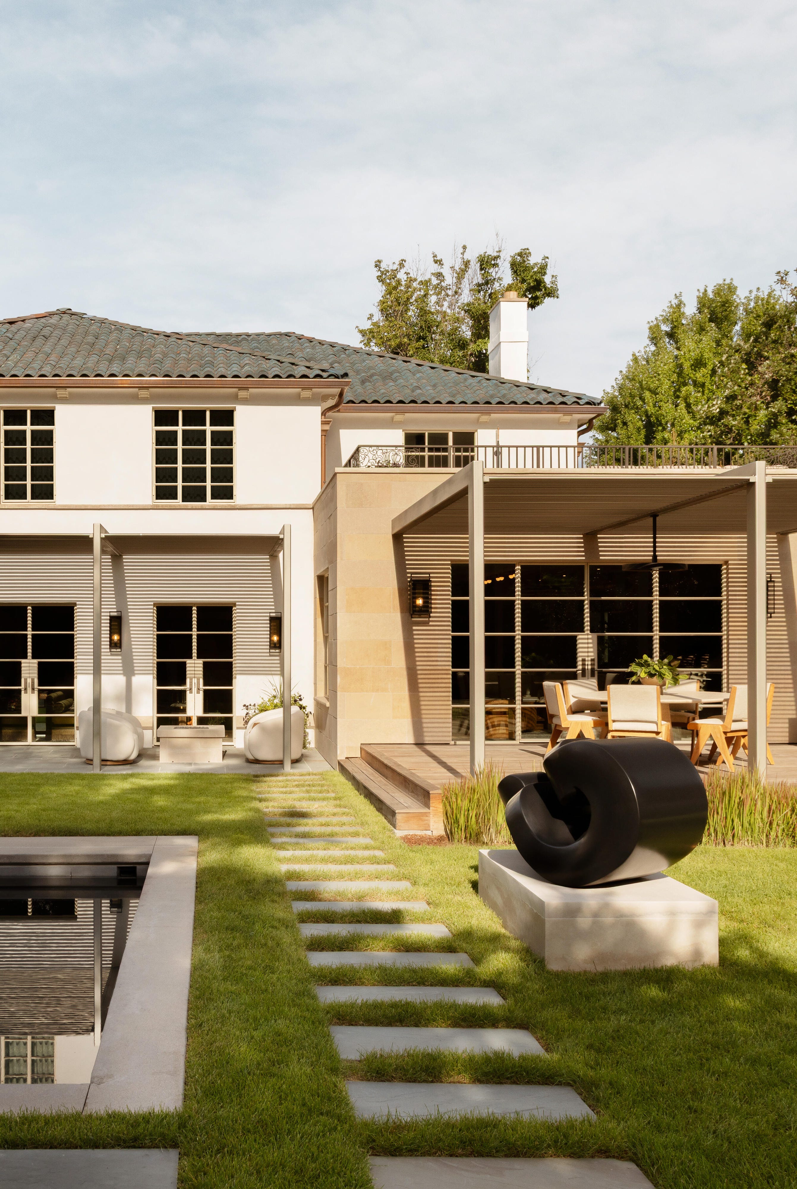 modern house with outdoor dining and a swimming pool