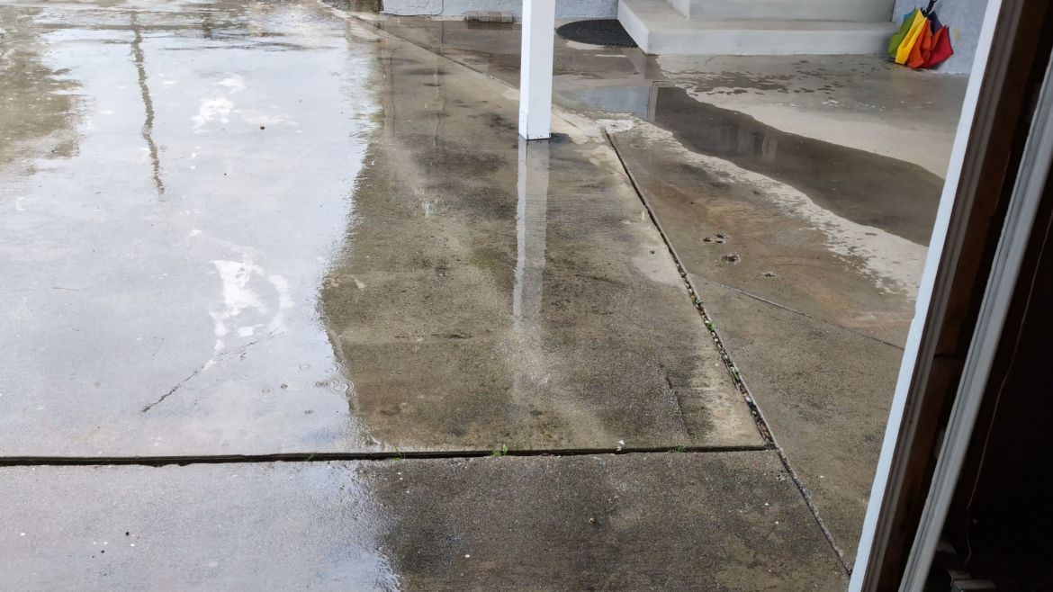 What kind of drainage solution would be best for this situation? French drain? Gutters? Build a curb? Pave it over?