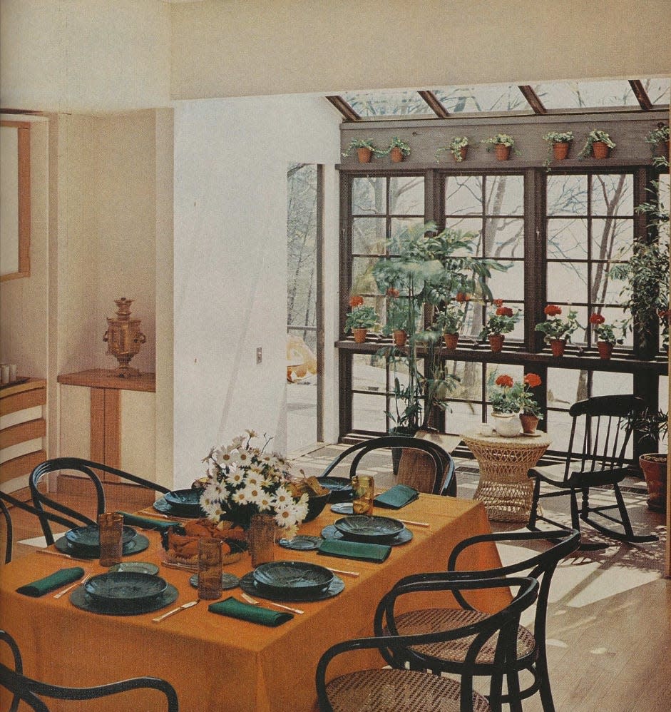 dining area with a view of a sunlit room filled with plants