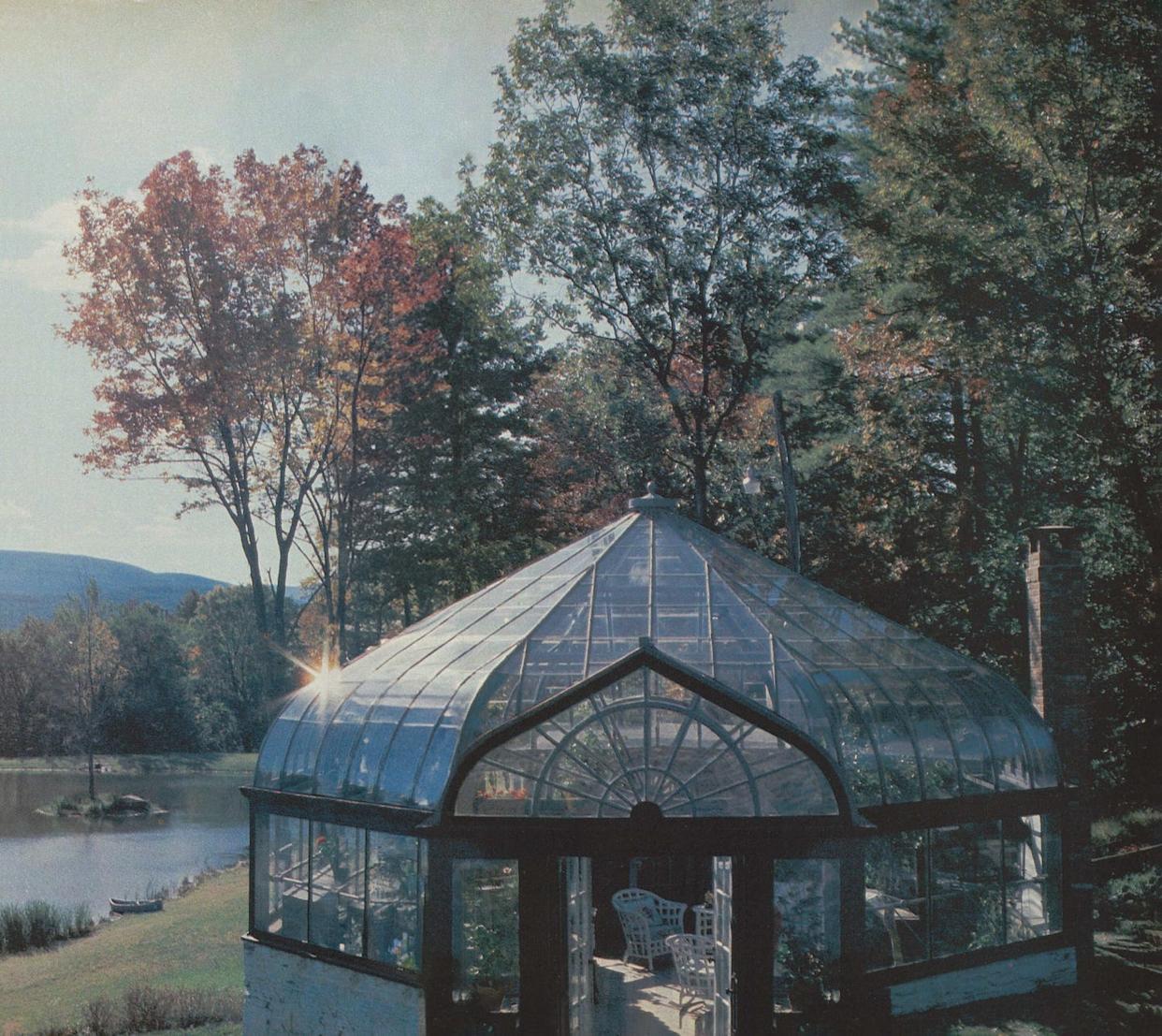 glass greenhouse beside a river