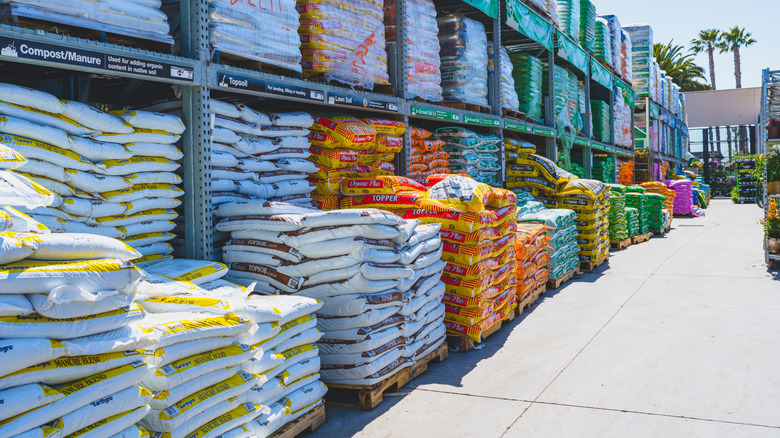 Bags of commercial compost and other garden amendments for sale in a garden center in the U.S.