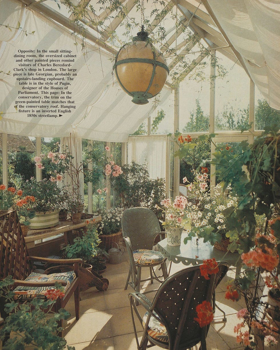 conservatory with glass skylight, filled with furniture and plants