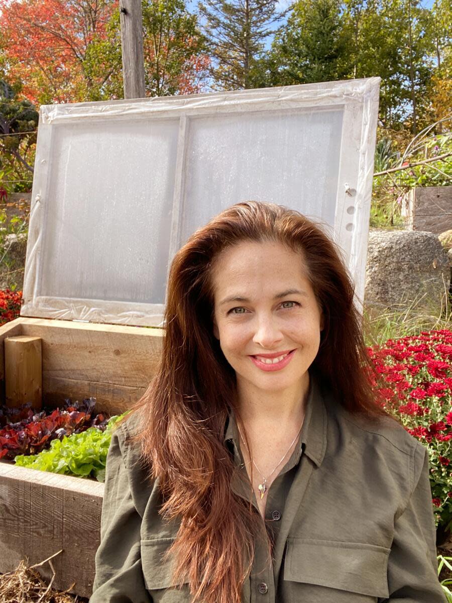 person in front of greenhouse