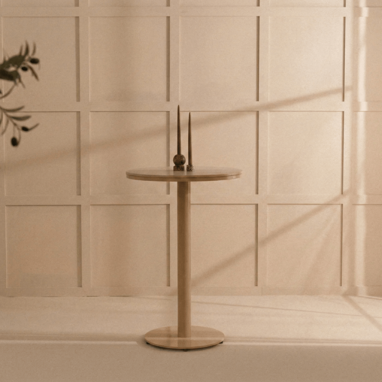 Ojamn, Garden Bar Table in a rotating gif showcasing it against a pale green background and in a cream-tinted, sun-lit interior.