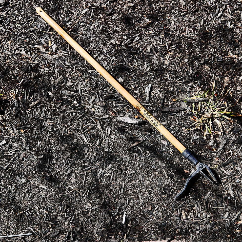 Gardening tool resting on mulch