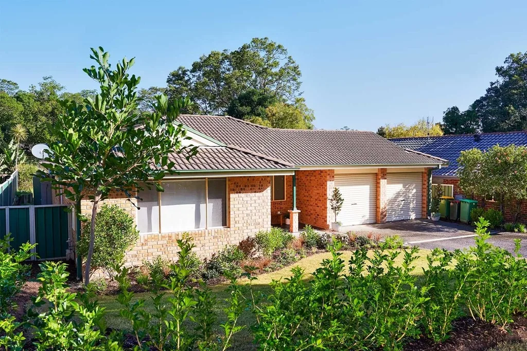 Brick house with a lush front garden