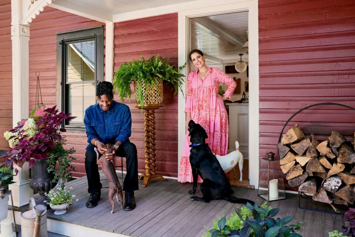 Suleika Jaouad’s Love Letter to a Two-Hundred-Year-Old Farmhouse – Garden & Gun A man, woman, and three dogs on the porch of a red farmhouse