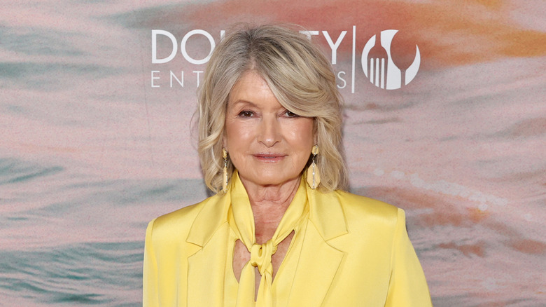 Martha Stewart in a yellow pantsuit, looking at the camera