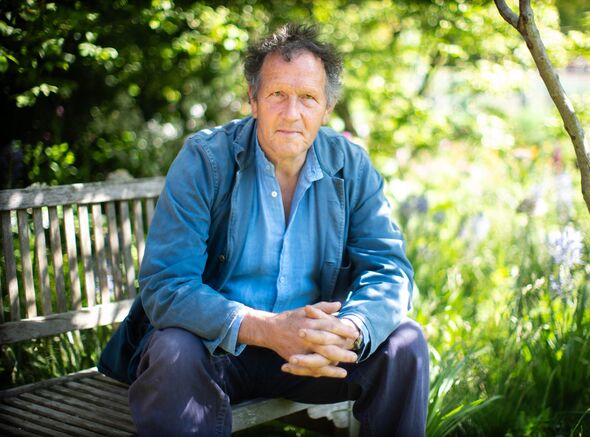 Monty Don sitting on a bench outside