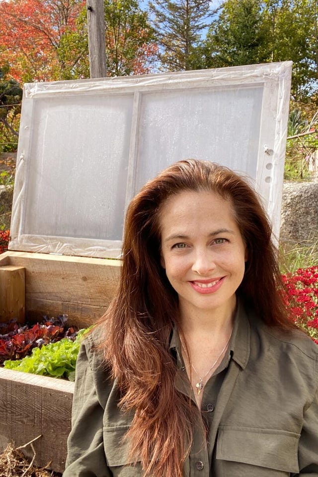 person in front of greenhouse