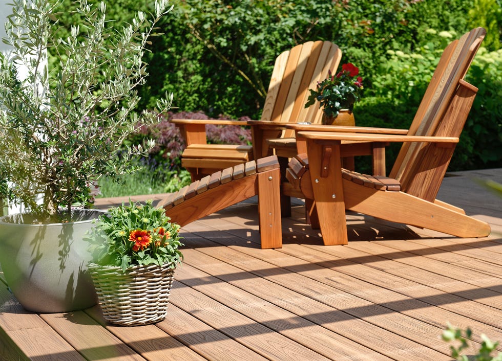 outdoor seating area with wooden chairs and decorative plants outdoor seating area with wooden chairs and decorative plants