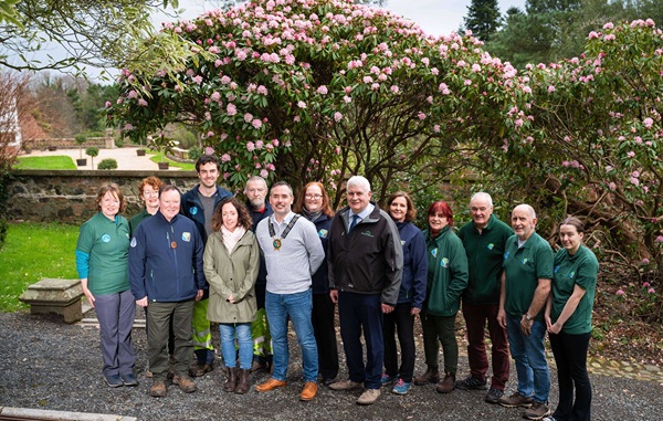 By the rhododendron bush pointing to the first signs of spring at the newly restored Annesley Walled Garden are (front row from left) Head Gardener, Alwyn Sinnamon; The National Lottery Heritage Fund Investment Manager Frances McNally; Newry, Mourne and Down District Council Chairperson, Cllr Philip Campbell and Forest Service Chief Executive Officer, John Joe O’Boyle with staff and volunteers.
