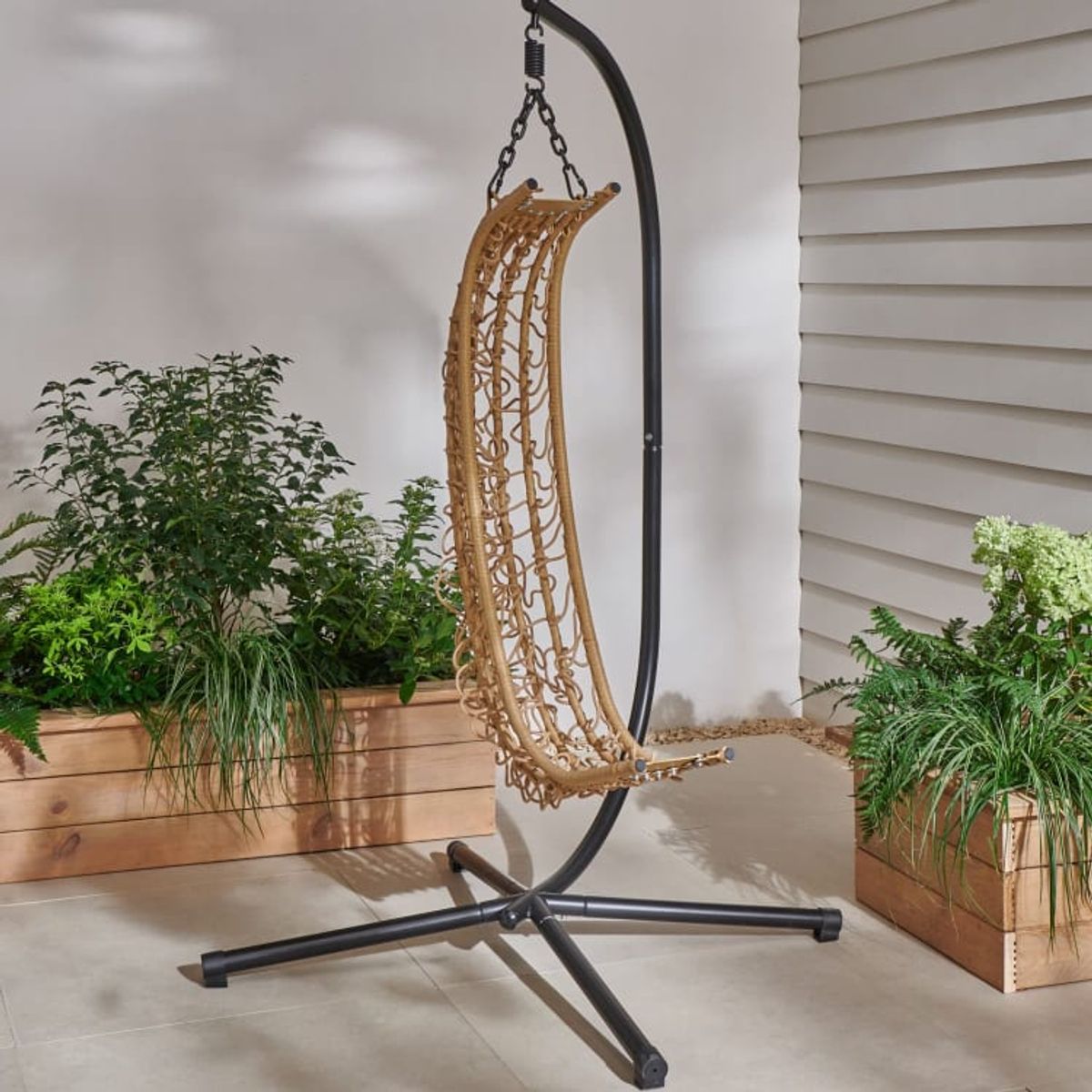 An image of a folding hanging egg chair in a garden