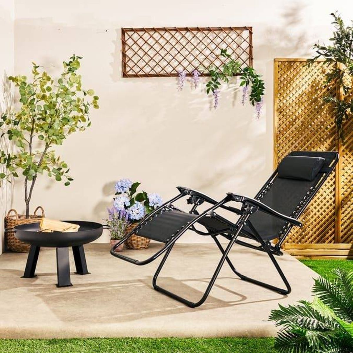 Black reclining chair in a garden.