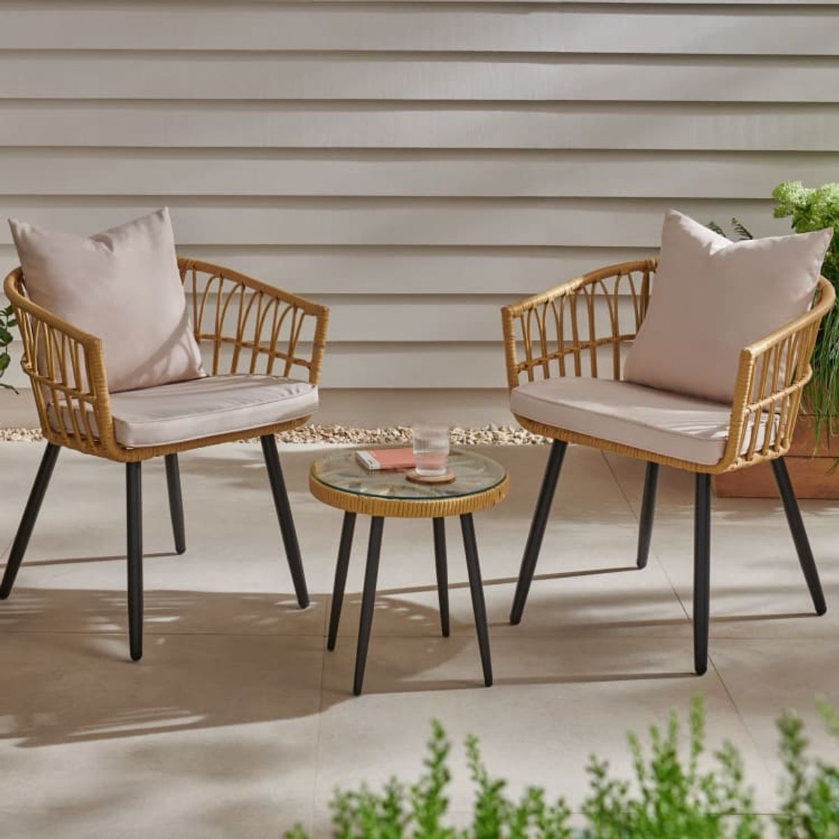 An image of a three-piece bistro set in an outdoors space