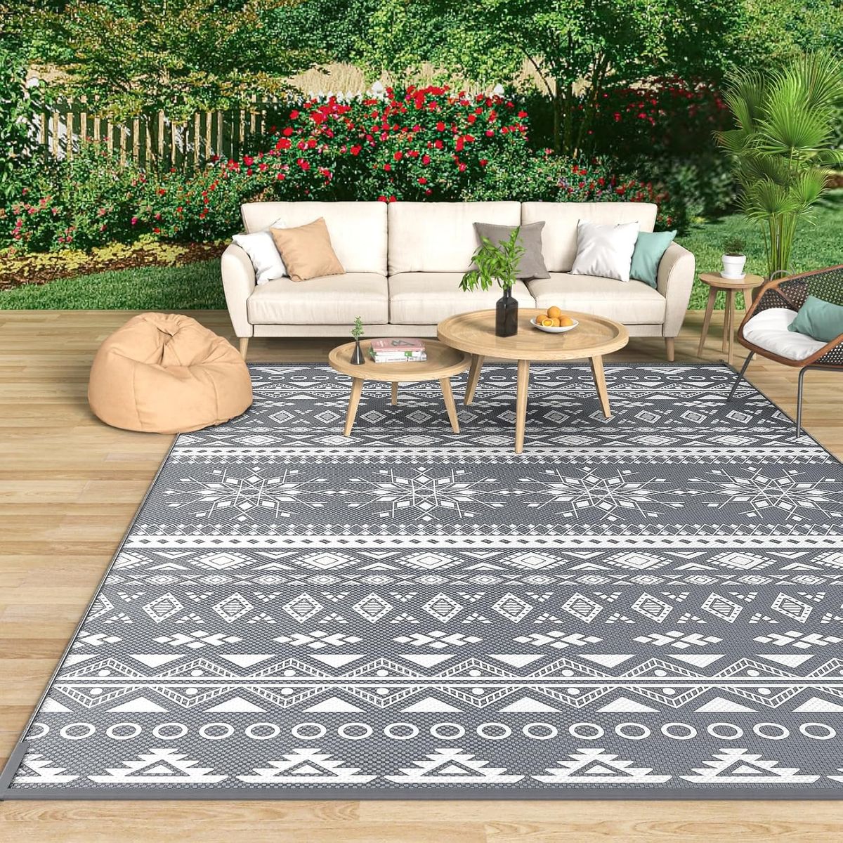 An image showing an outdoors space with rattan furniture and a rug on a patio