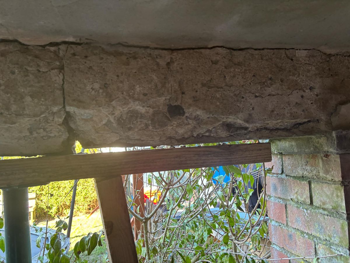 Part of the wooden supports holding up the crumbling balcony.