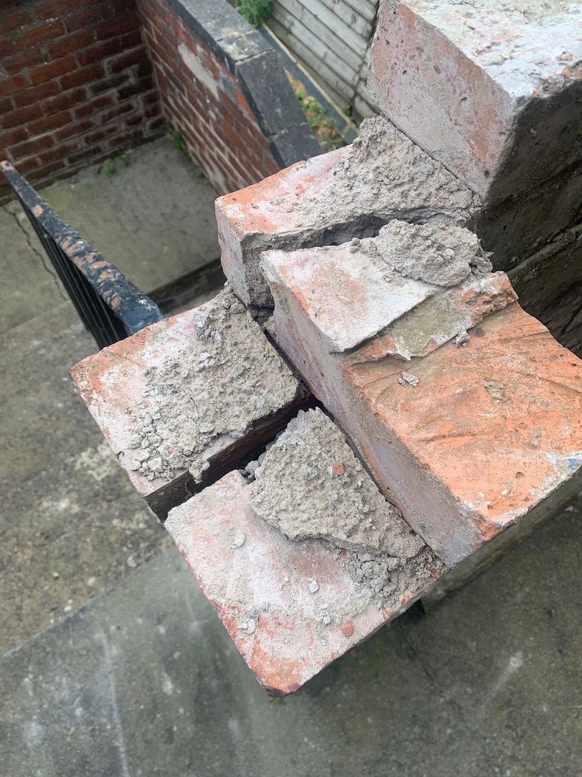 The brick wall is visibly crumbling away.
