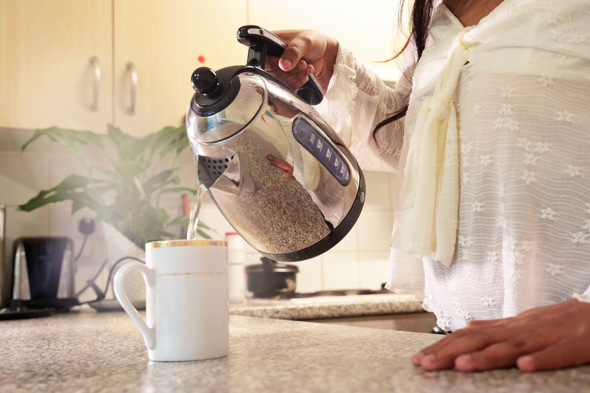 pouring water from kettle into mug