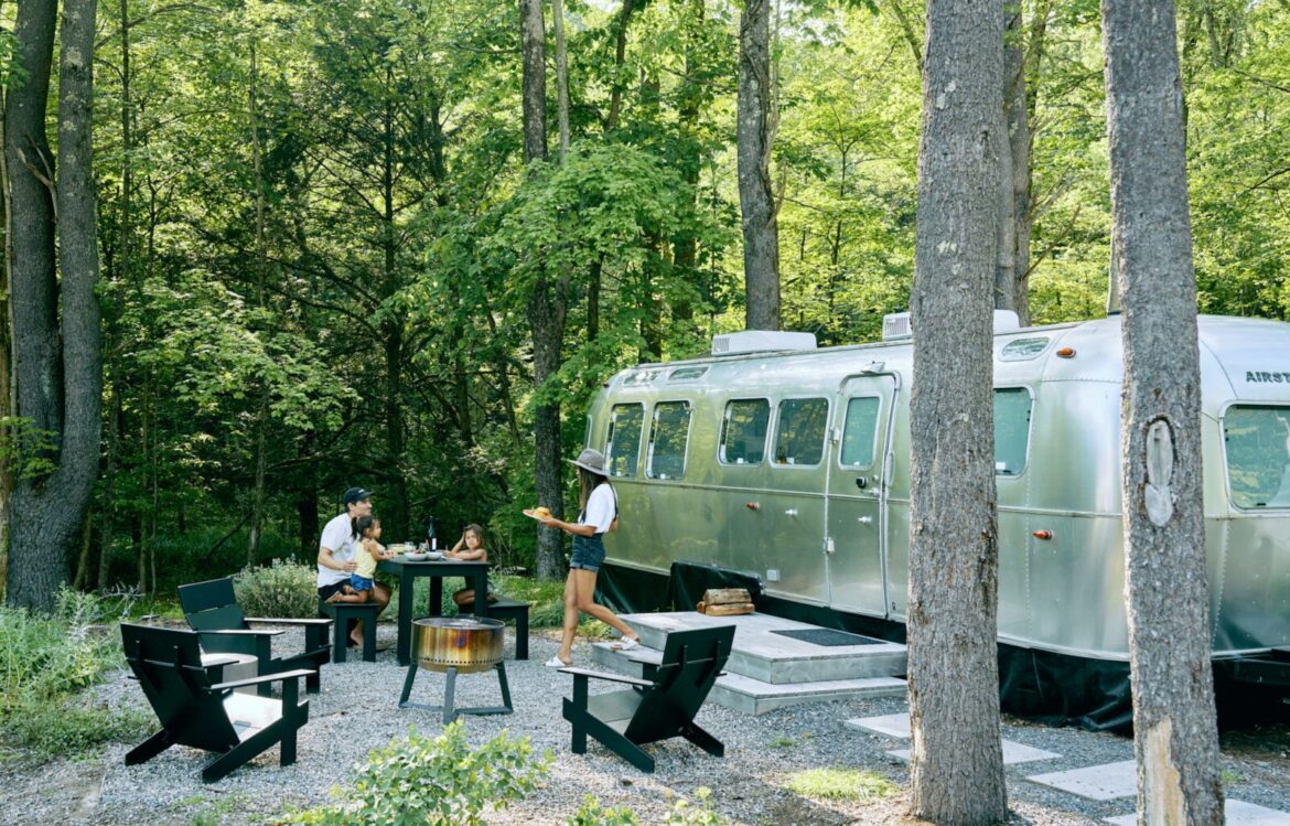 AutoCamp Asheville Brings Luxe Airstream Glamping to the Blue Ridge – Garden & Gun A family camps outside an airstream