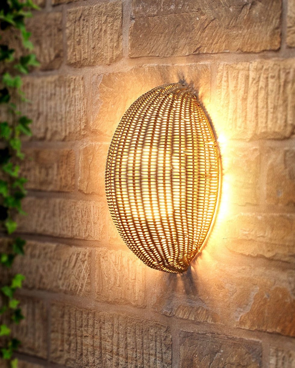 Barca rechargeable rattan wall light, Atkin and Thyme wallmounted light fixture on a textured brick wall