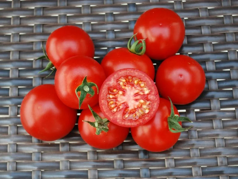 BadaBing! F1 Tomato A close-up of 'Bada Bing' cherry tomatoes against a background of dark wicker