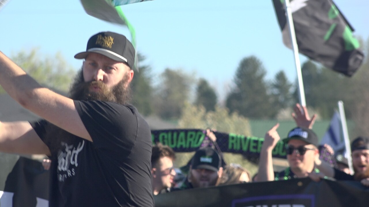 Bryce Tuttle leads the River Guard on their march to the stadium