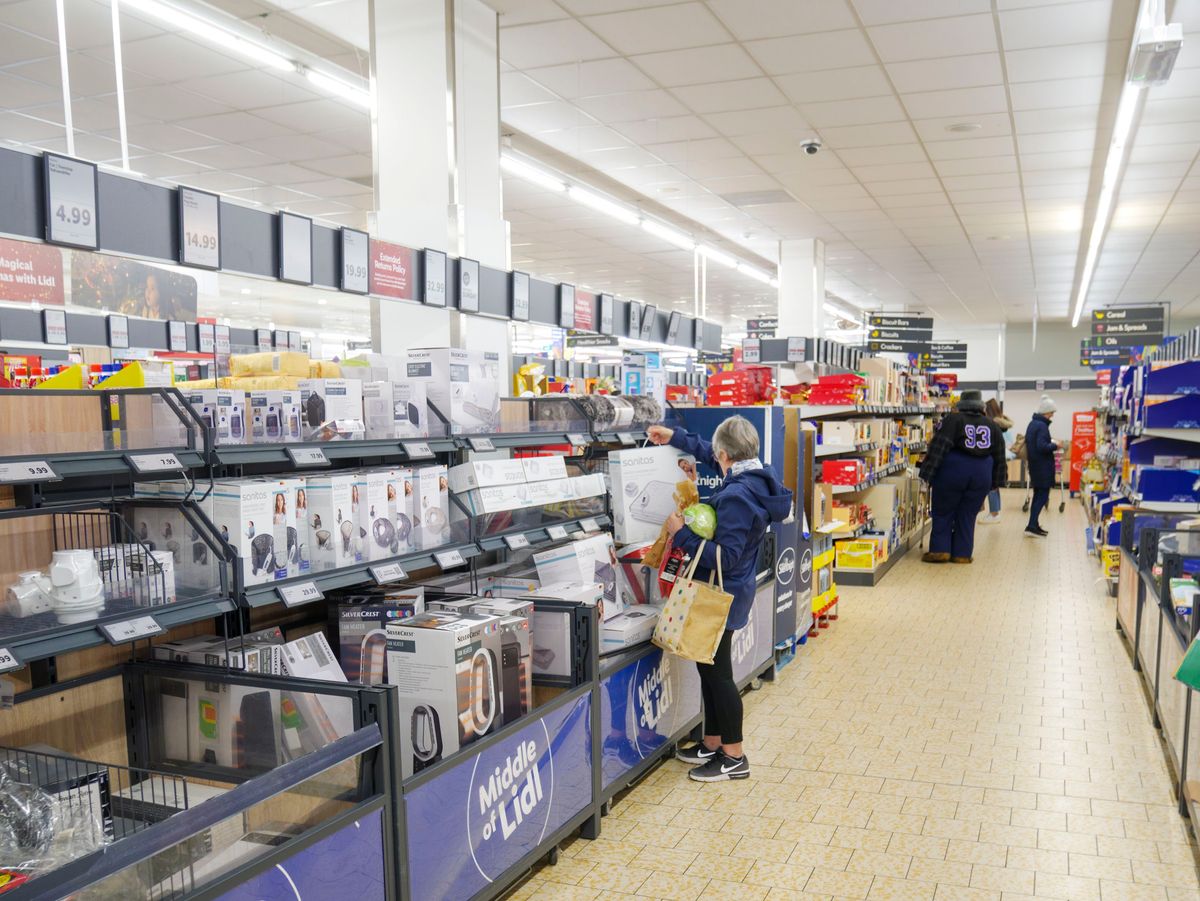 People shopping in the middle of Lidl supermarket aisle, UK. (Photo by: Alex Segre/UCG/Universal Images Group via Getty Images)