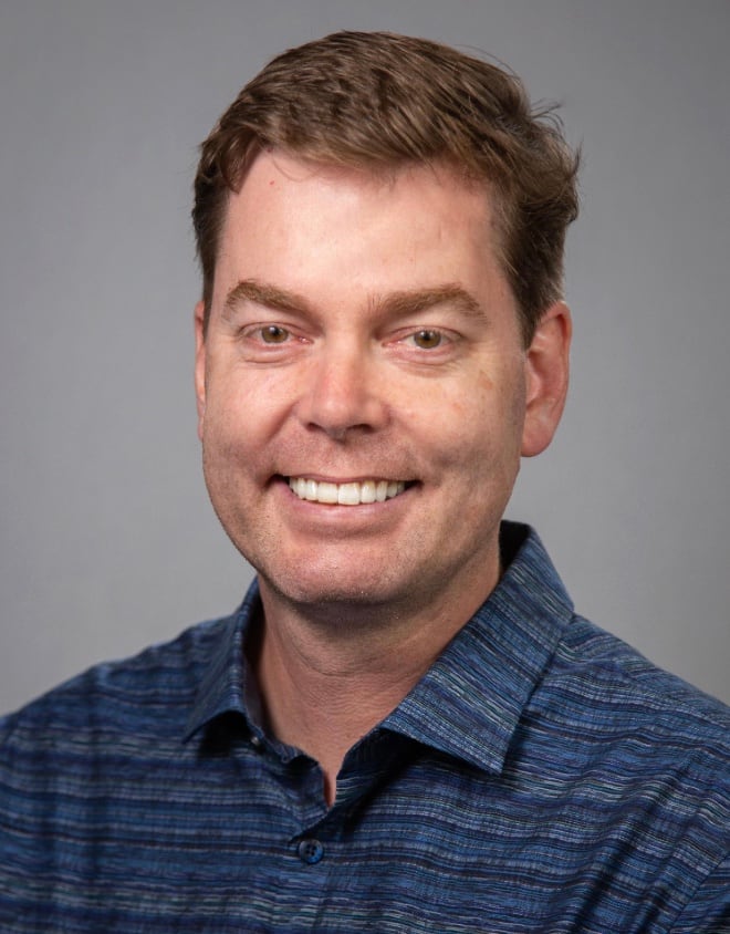 Portrait of smiling man wearing blue shirt.