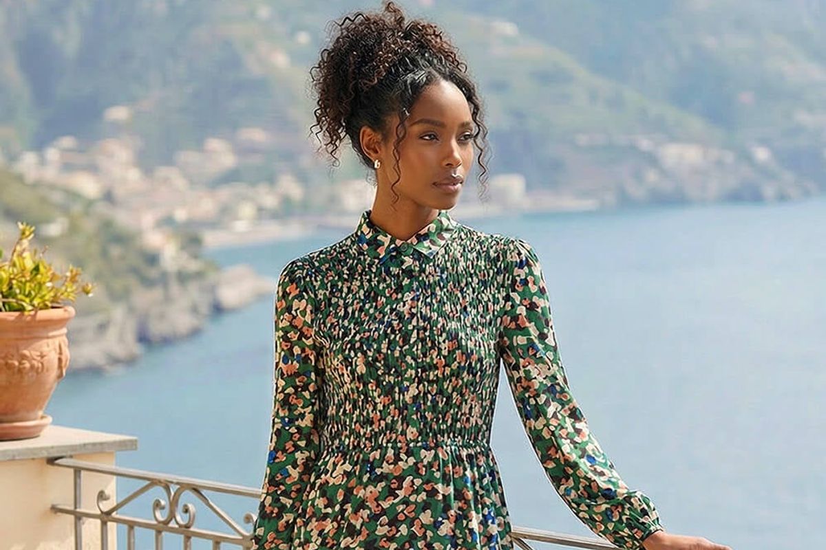 A woman wearing the Green Speckled Print Shirred Midi Dress