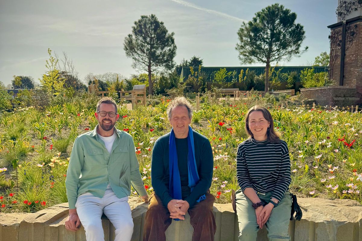 Monty Don sat on a wall with two gardeners in The Queen Elizabeth II Garden which is opening in The Regent's Park