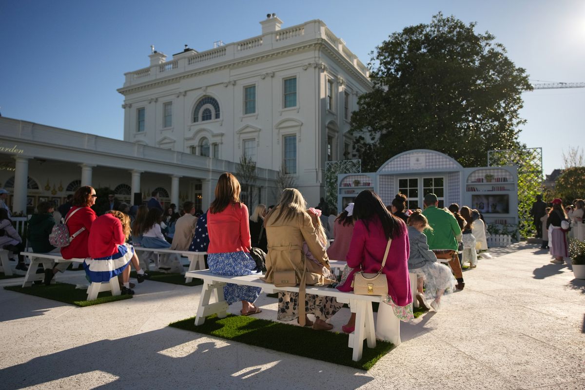 Strips of fake grass were placed under rows of white benches among other places