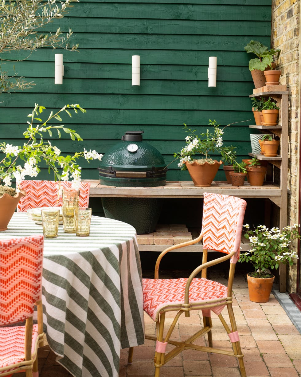 David Hunt lighting outdoor kitchen big green egg ceramic bbq pictured in an outdoor kitchen with table dressed in striped linen
