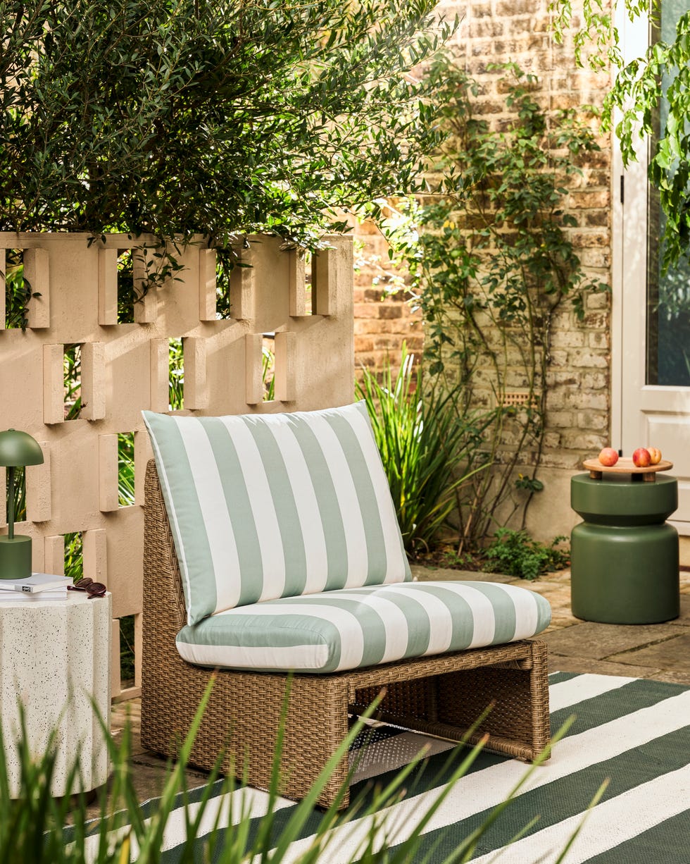 outdoor seating area with a striped chair and table