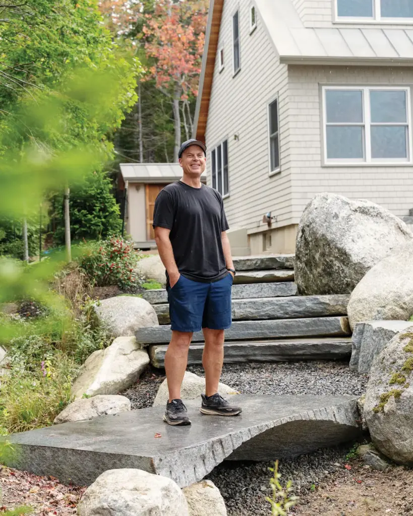 Rocks Are How Mainer Joe Norton Expresses His Creativity Maine stonemason Joe Norton standing amongst one of his hardscapes
