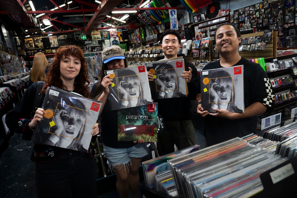 April 18, 2026 - Jenna Dawson, Denise David, Harry Kip, and Andrew Mendoza show their signed Hayley Williams vinyls, an exclusive to Sound Garden, on Record Store Day.