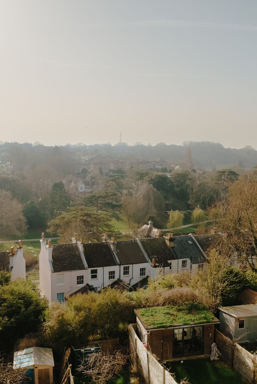 Inside a beautifully restored Victorian terrace in Hastings with a rich, layered colour palette view of houses and trees under a hazy sky