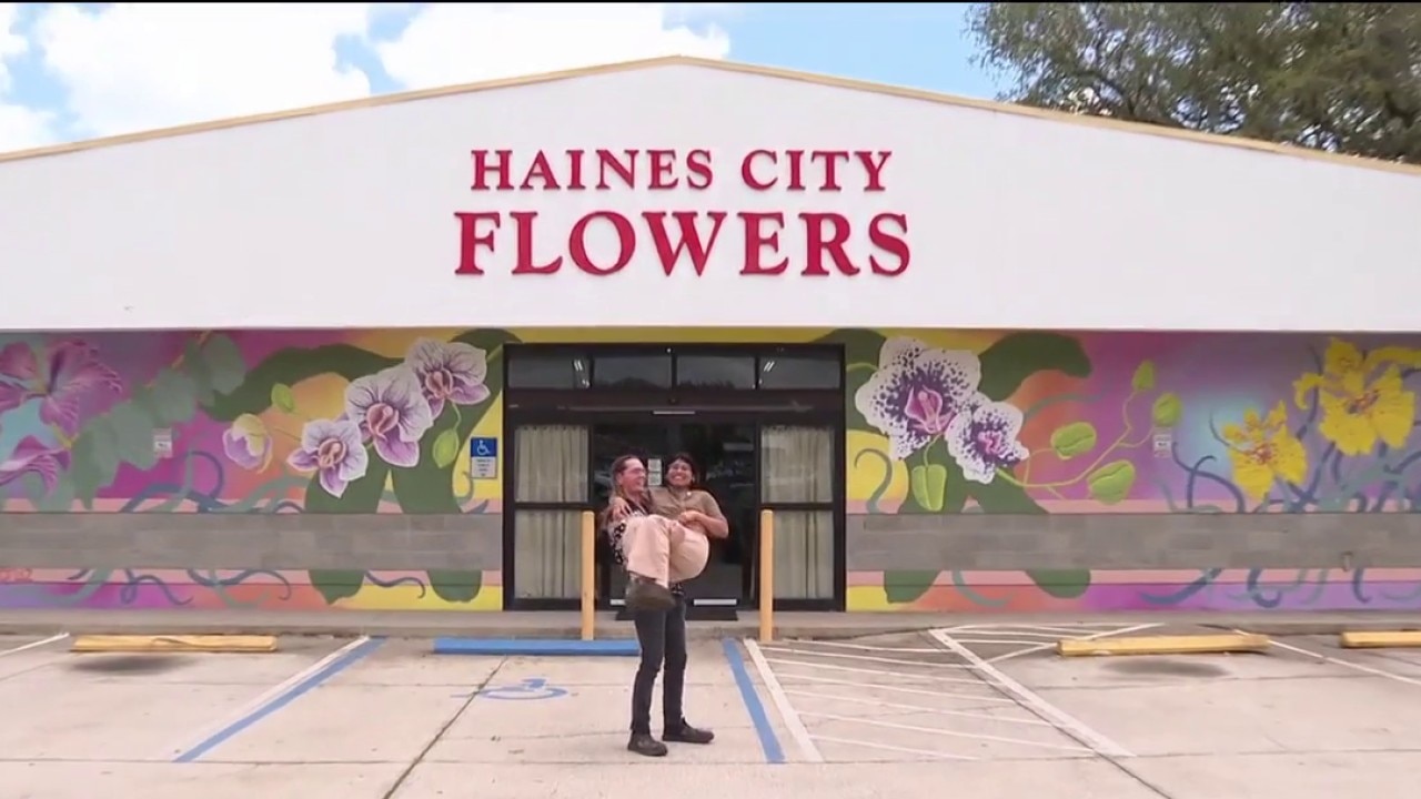 Artist paints meaningful flower shop mural