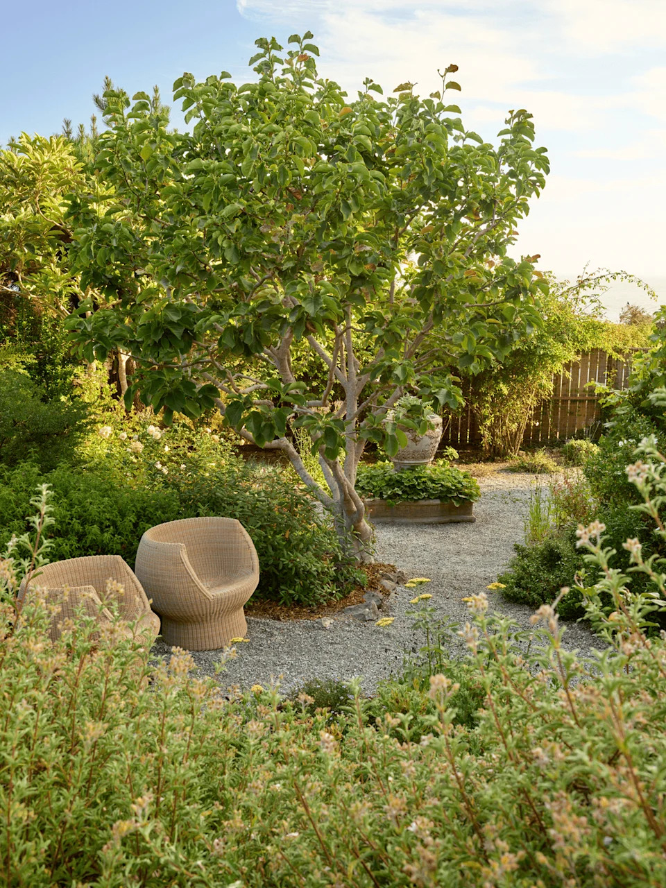 seating within a lush cottage garden in California