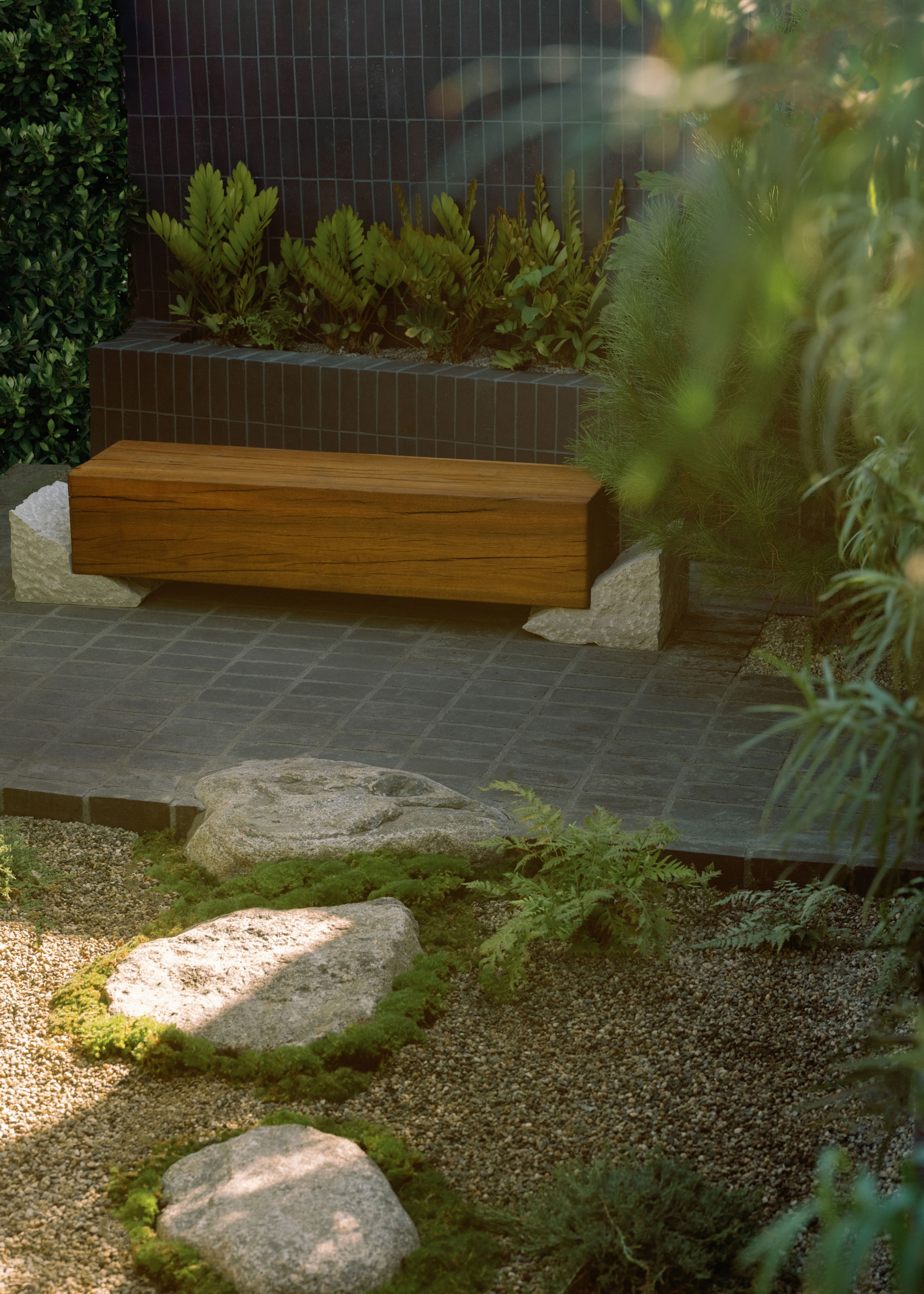 Zen inspired garden with rocks, gravel, bench and planting