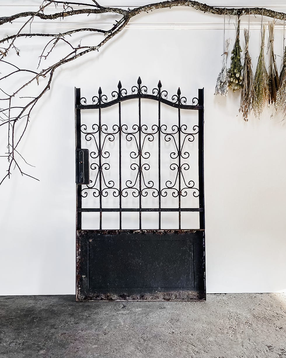 Decorative black metal gate with intricate design.