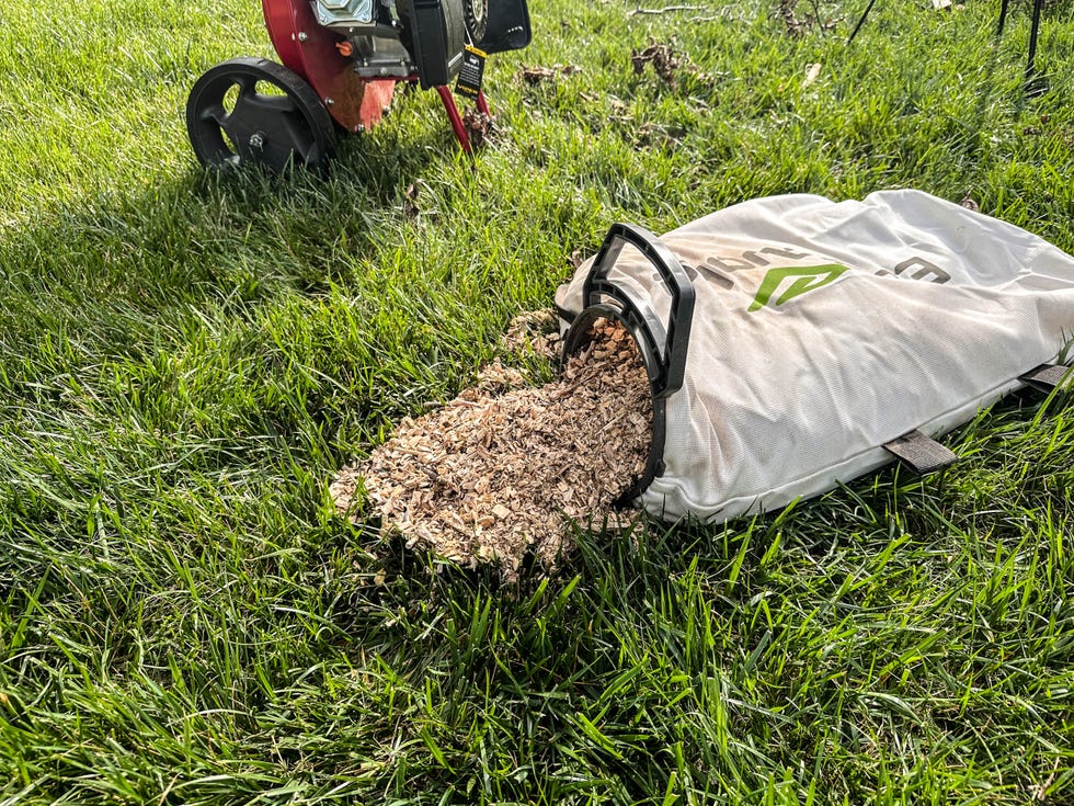 Grass and a bag spilling out wood chips.