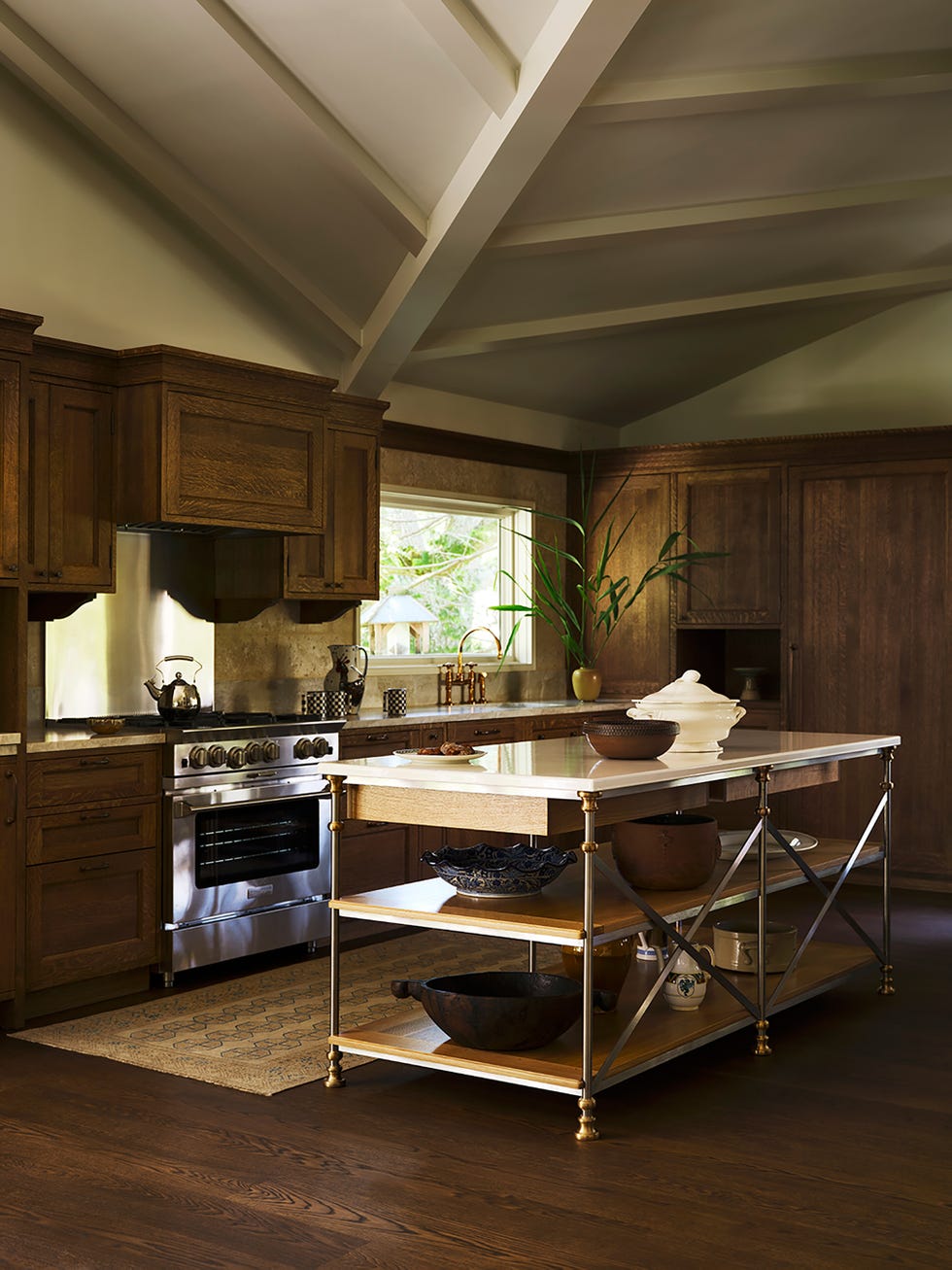 Modern kitchen with a central island and wooden cabinets.