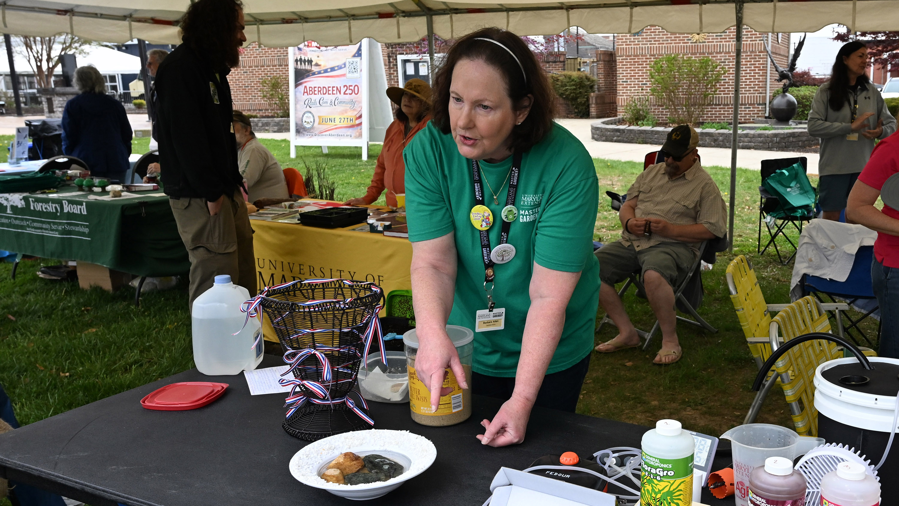 Barbara Allen, a Harford County Master Gardener, talks about making puddlers and promoting pollinators health during the Earth Day celebration at Festival Park in Aberdeen on Saturday. (Brian Krista/Staff)