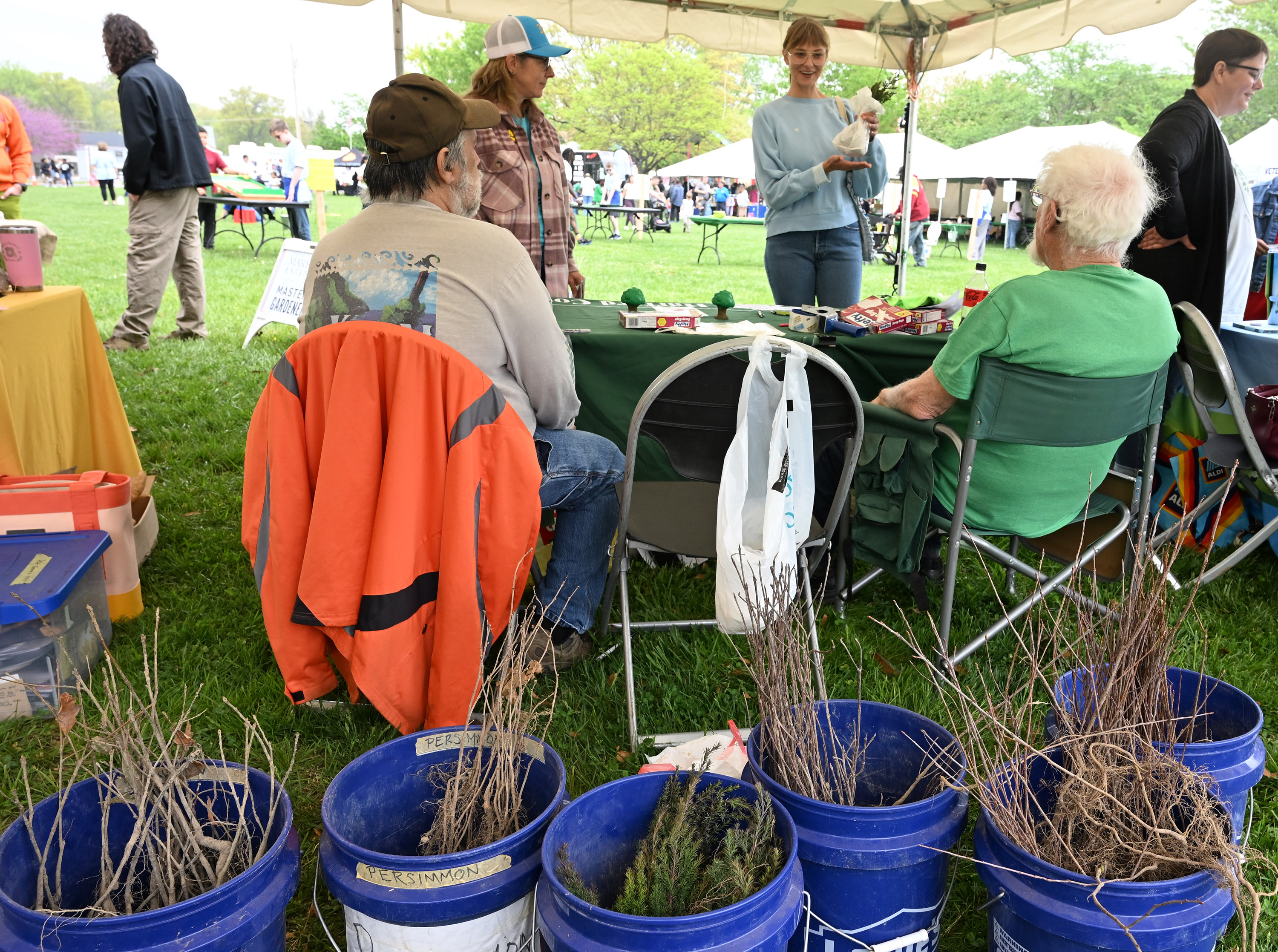 Members of the Harford County Forestry Board give away free native tree seedlings to visitors during the Earth Day celebration at Festival Park in Aberdeen on Saturday. (Brian Krista/Staff)