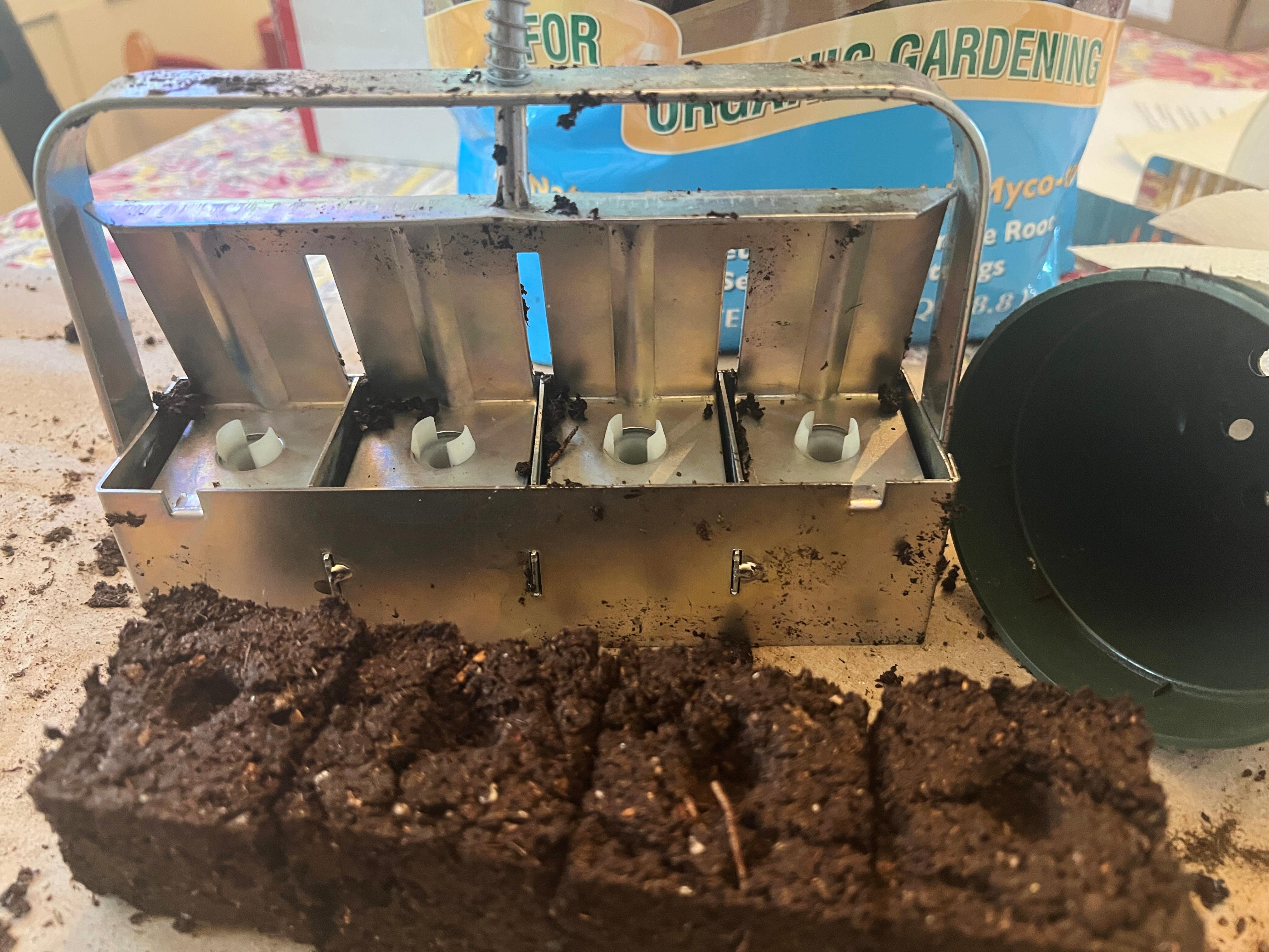 Freshly made soil blocks and a 4-cell, hand-held soil blocker
