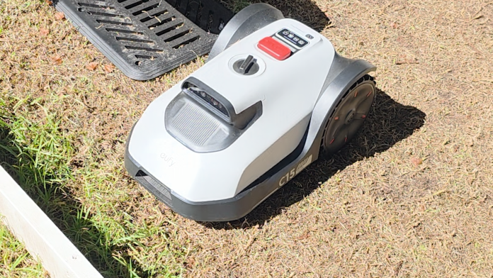 The robot lawn mower, showing very very short grass around where the mower can reach.
