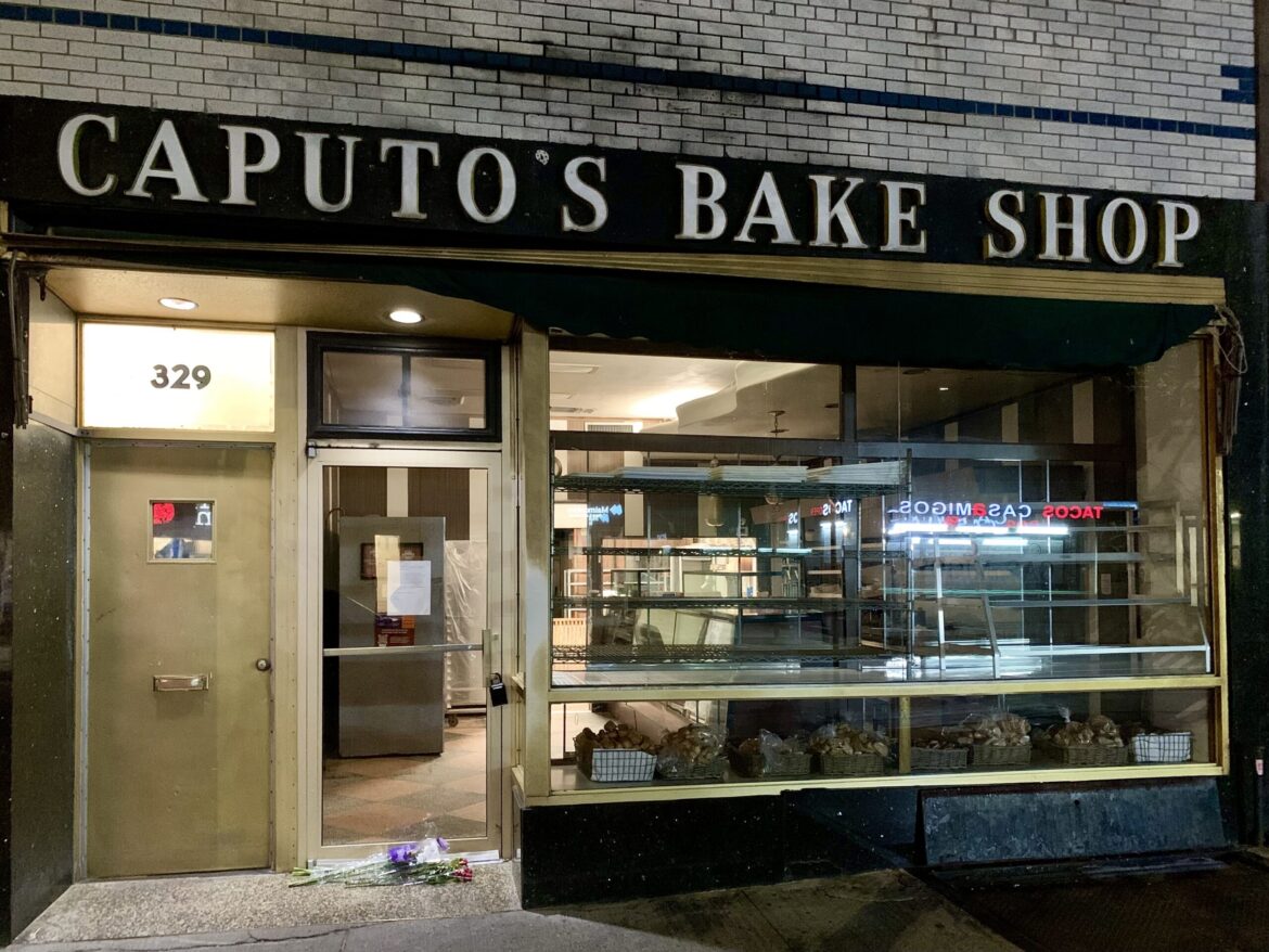 Carroll Gardens’ Caputo’s Bakery closes after 124 years Caputo’s on Monday night, with farewell flowers visible outside its door. Photo: Mary Frost/Brooklyn Eagle.